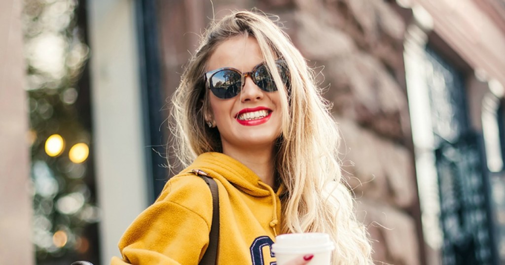 Woman wearing fashion sun glasses outside a building