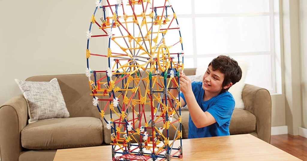 Boy playing with toy amusement park building set