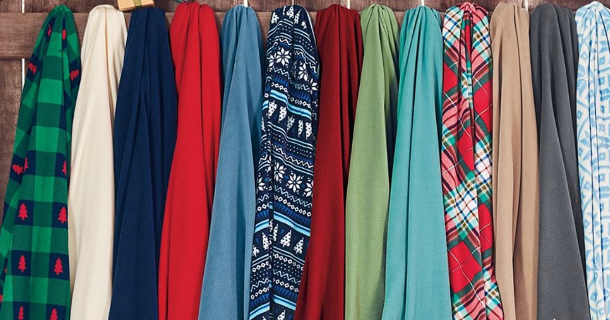 various Lands' End throw blankets hanging on a wooden fence