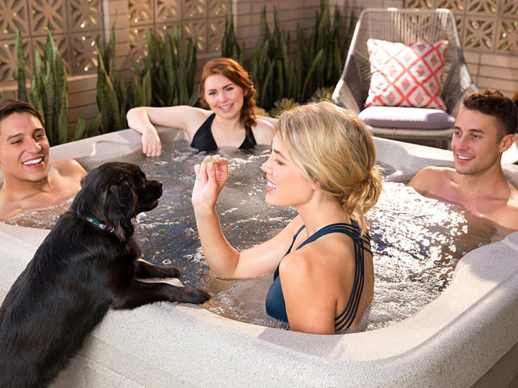 four people in hot tub