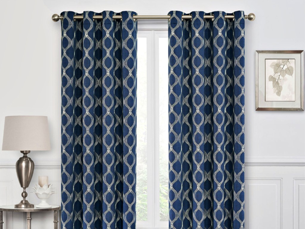 Geometric Blue and Gold Curtain Panels on window of livingroom with lamp and picture on sides