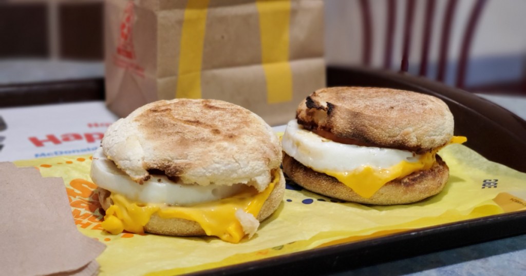 two egg mcmuffins on tray with mcdonalds bag in the background