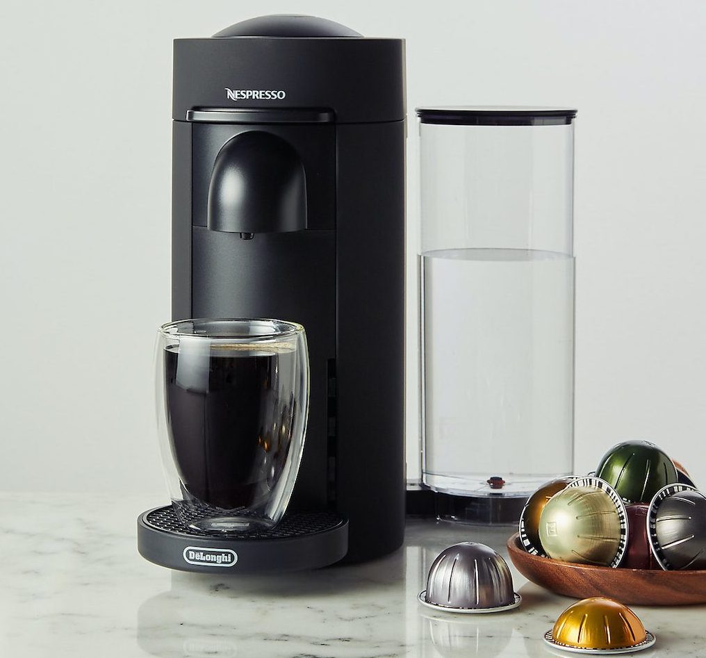 single serve coffee maker with pods sitting next to it - nespresso black friday