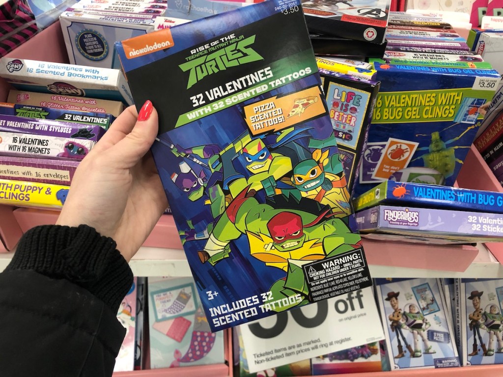 hand holding box of Ninja Turtles valentines