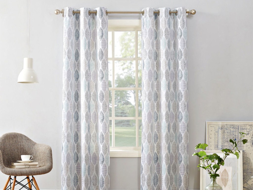 Curtain Panel on window in livingroom with chair and plant
