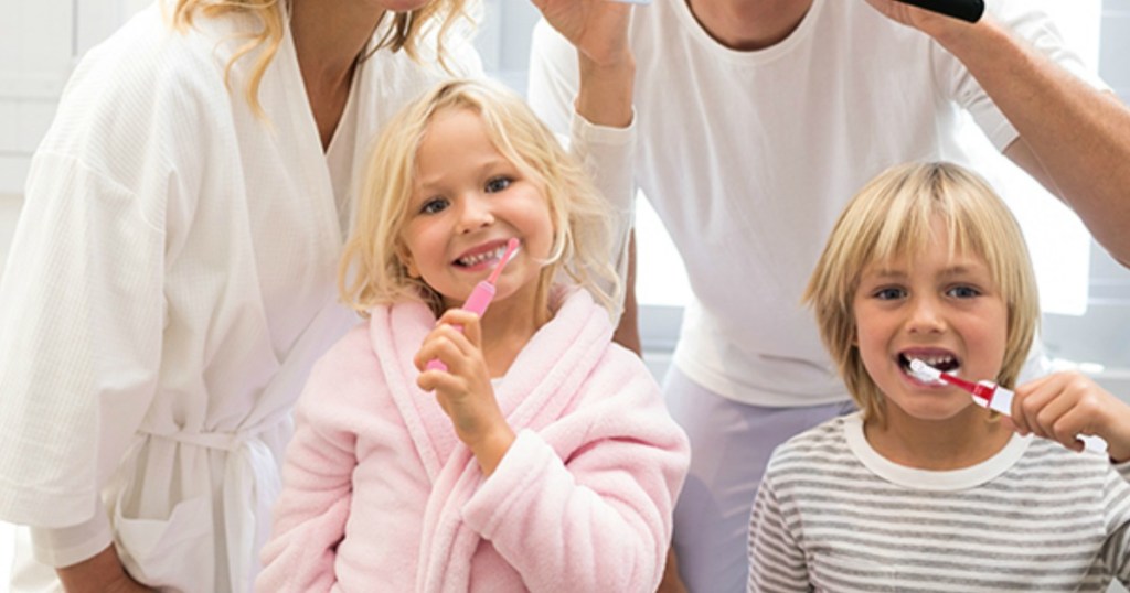 kids brushing their teeth with electric toothbrushes