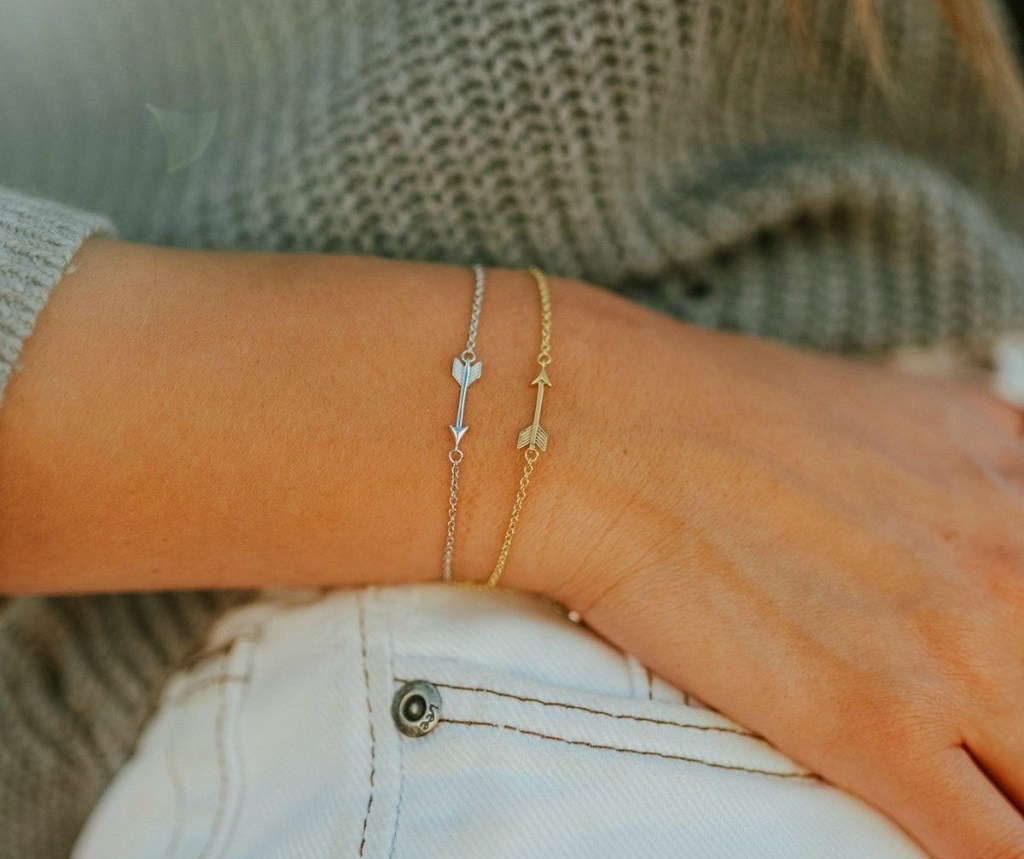 woman wearing 2 Pura Vida Arrow Chain Bracelets