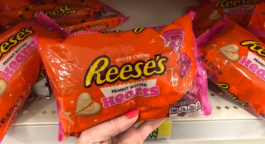 hand holding bag of Reese's Hearts