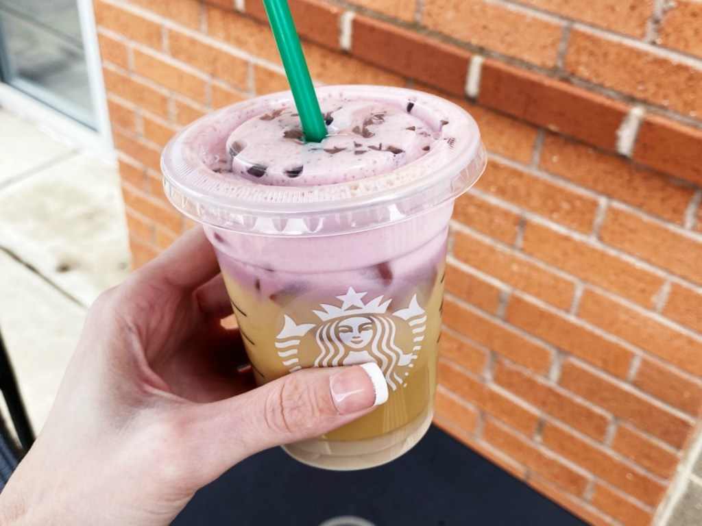 Woman holding Starbucks Secret Chocolate Strawberry Cold Brew outside