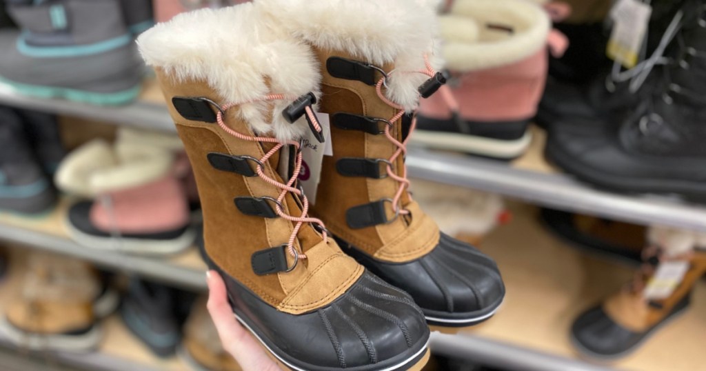 hand holding little girl winter boots at Target