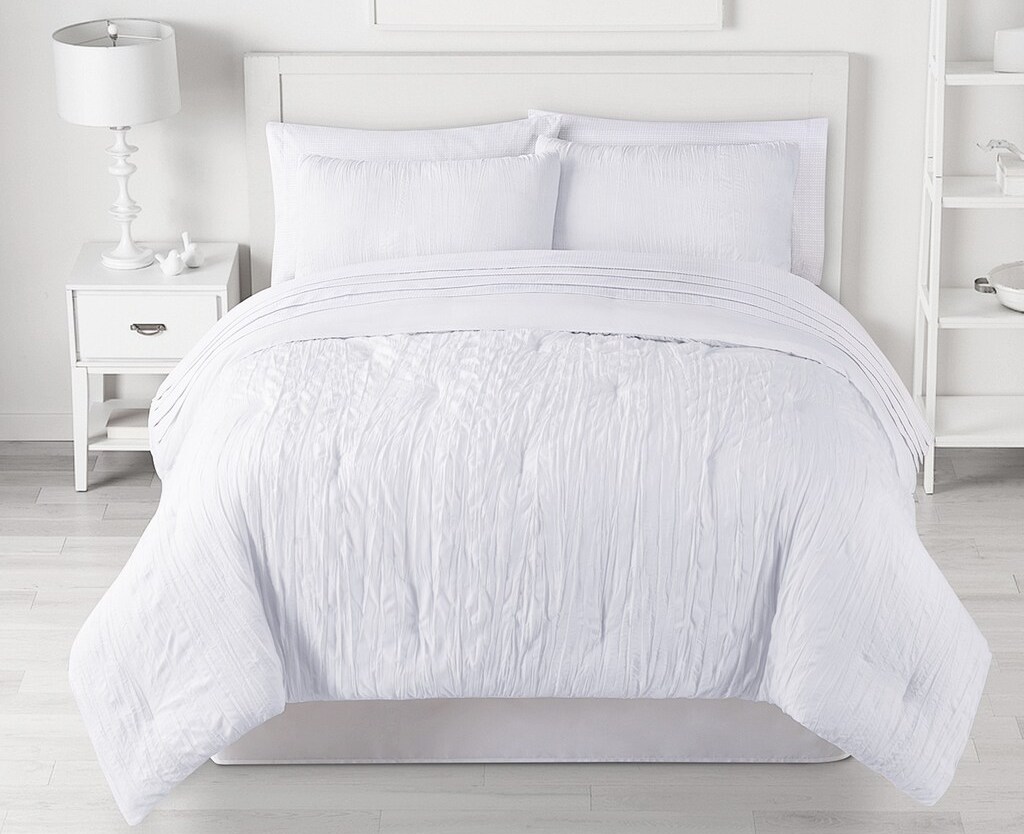 bed with white bedding set on it