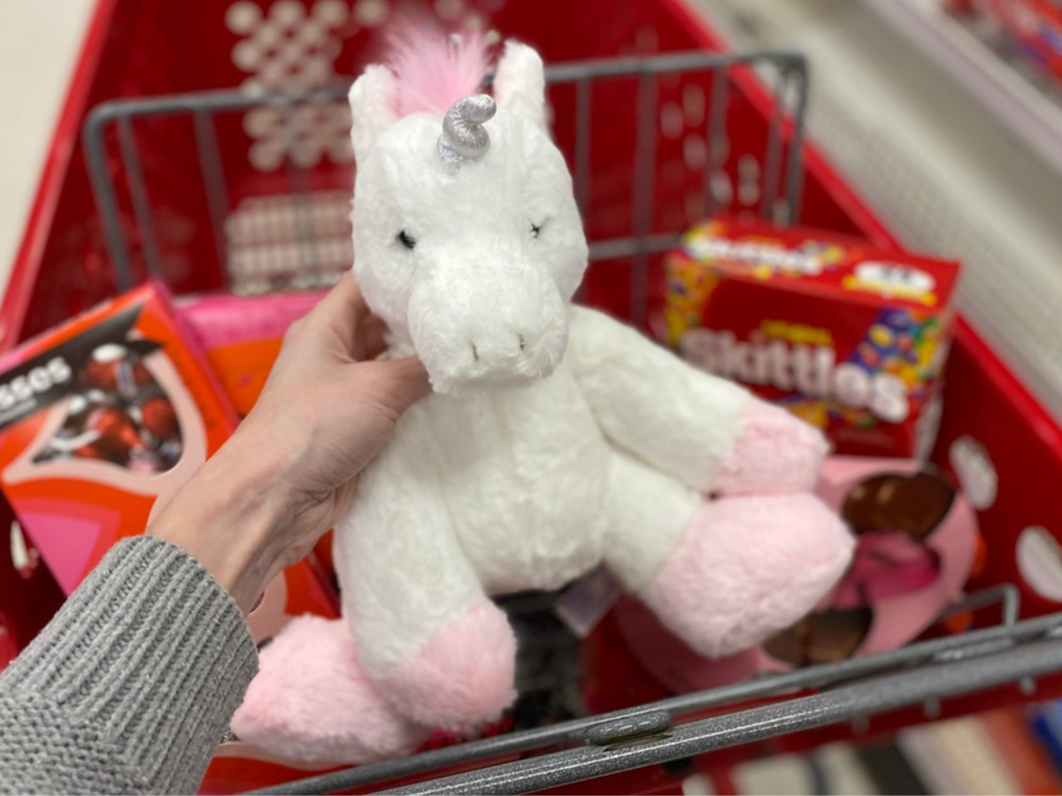 hand holding white and pink unicorn plush