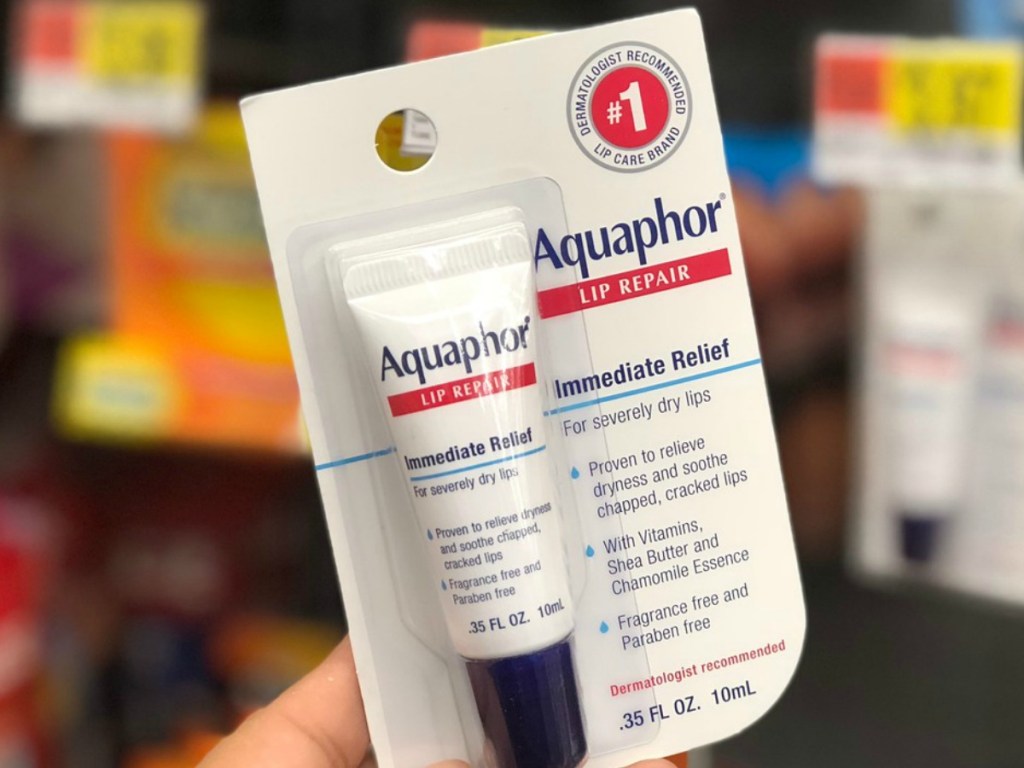 hand holding package with lip ointment tube in store