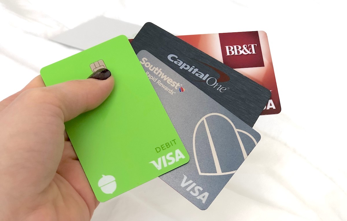 hand holding 4 different bank visa cards