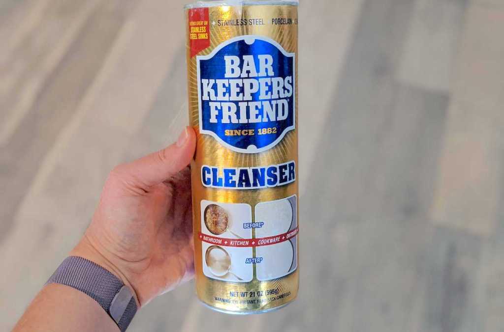 hand holding a bottle of bar keepers friend