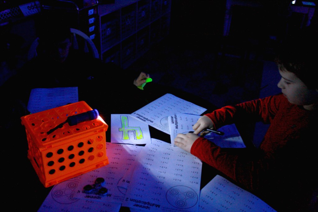 boy playing math game in dark