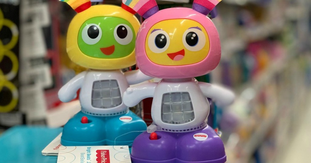 two alien looking toys in yellow and pink by store display