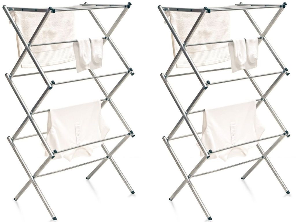 two metal folding drying racks with clothes hanging on them drying