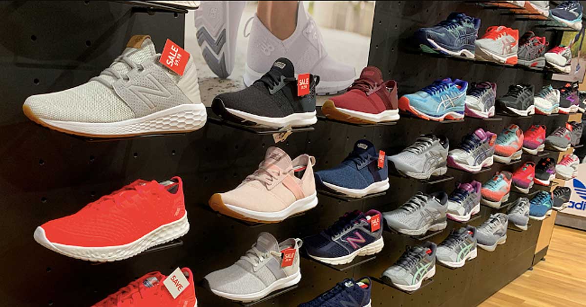 wall of women's running shoes on display in store