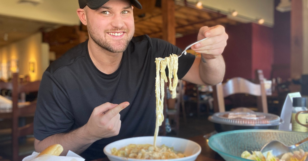 man eating pasta