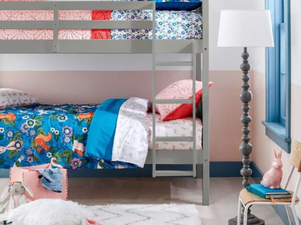 childrens bedroom with bunkbeds, rug, lamp and chair 