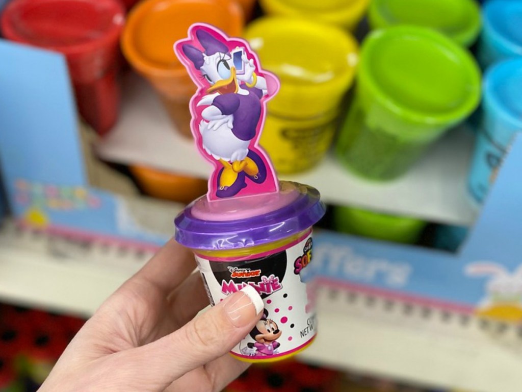 hand holding cup with a duck character on top