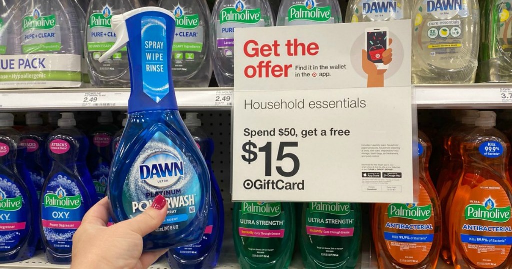 hand holding dish liquid nest to a store sign