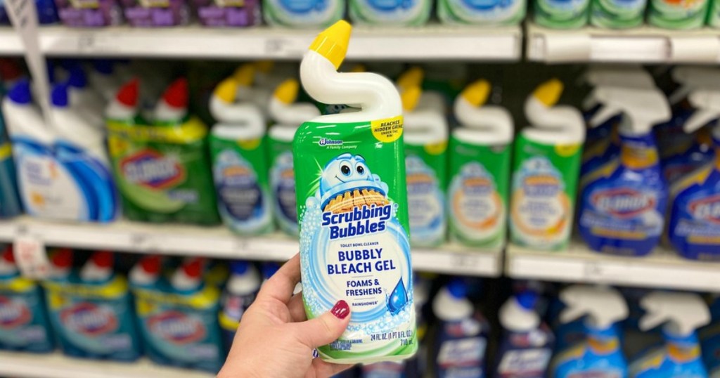 hand holding manual toilet bowl cleaner in a store