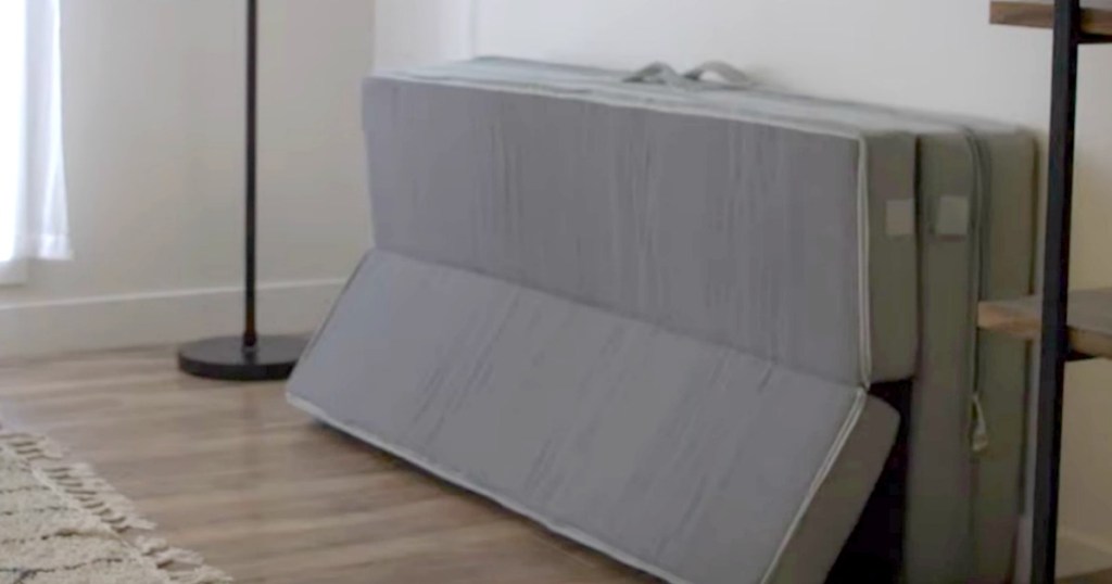 mattress topper laying on wall in livingroom