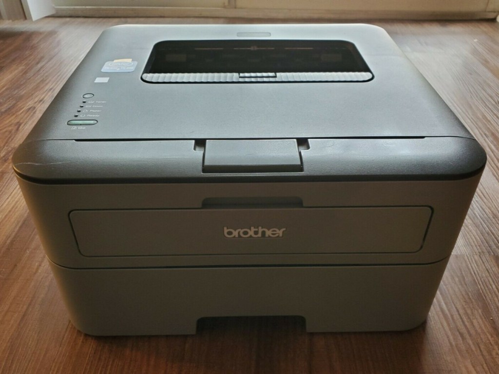 large black printer on wood table