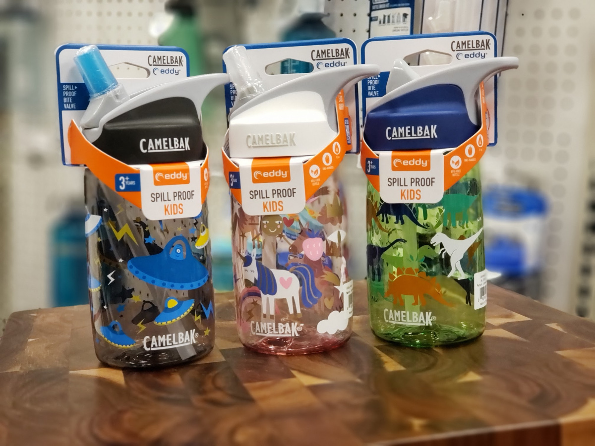 3 small camelbak water bottles on wood surface
