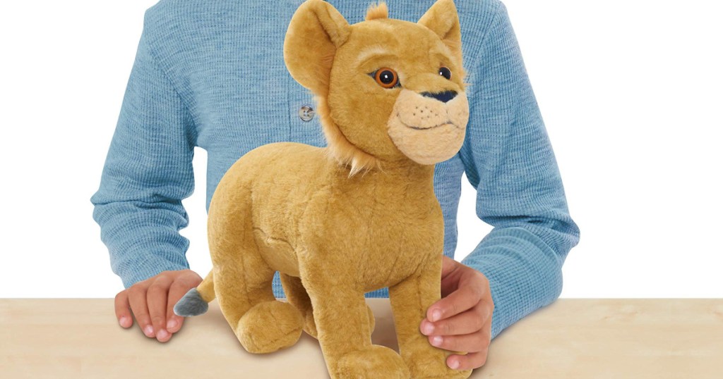 Child holding Disney Simba Plush