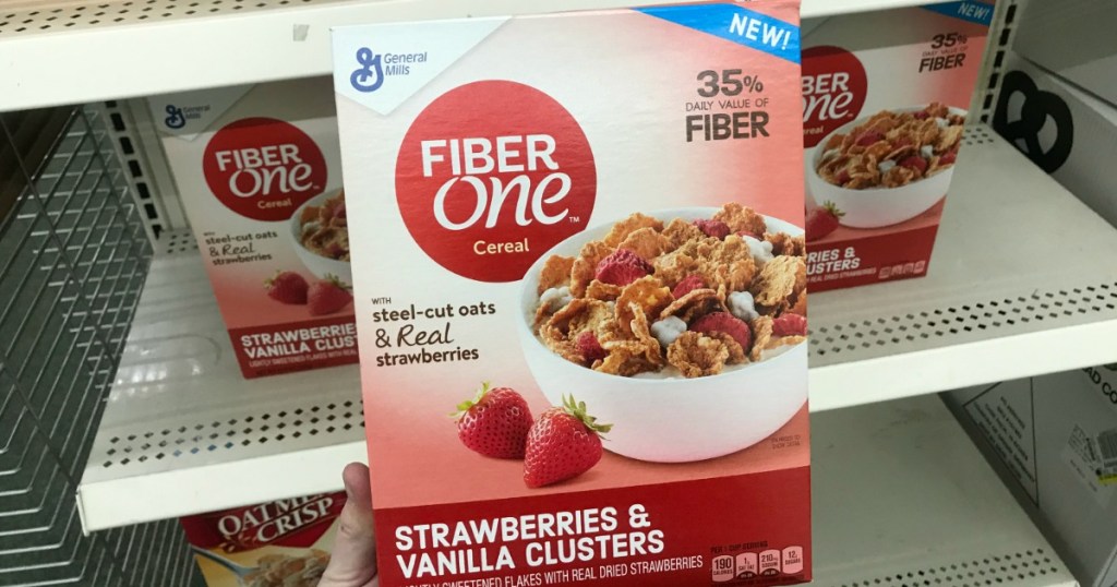 Woman holding Fiber One Strawberries Cereal at dollar Tree