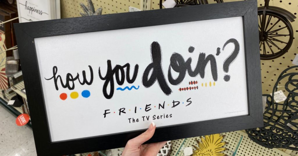 woman hand holding Friend's How You Doin Sign in hobby lobby