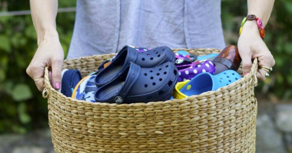 holding basket of crocs