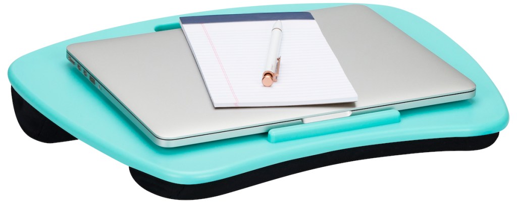 lapdesk with a computer and notepad sitting on it
