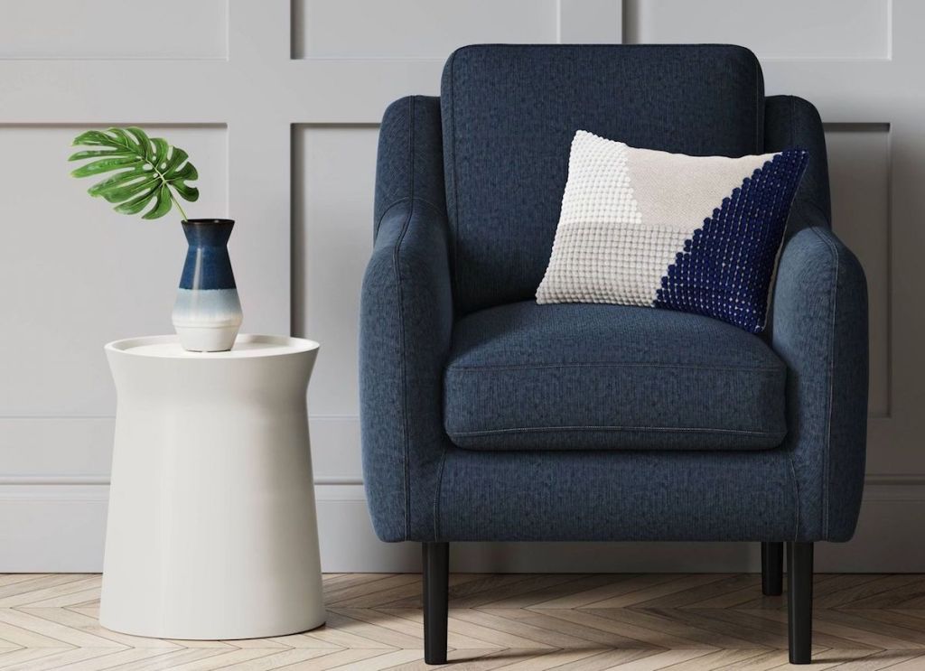 room with side table and blue accent chair