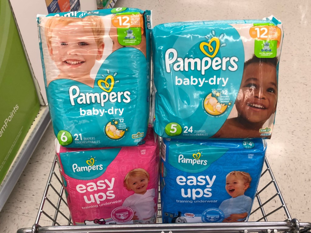 four diaper packages in cart in store aisle