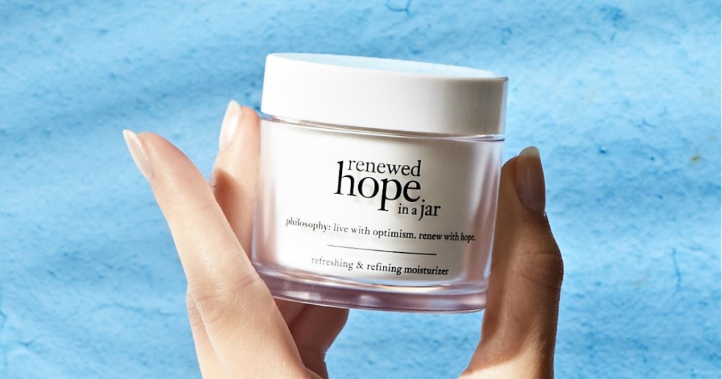 Woman holding Philosophy Renewed Hope in a Jar Moisturizer