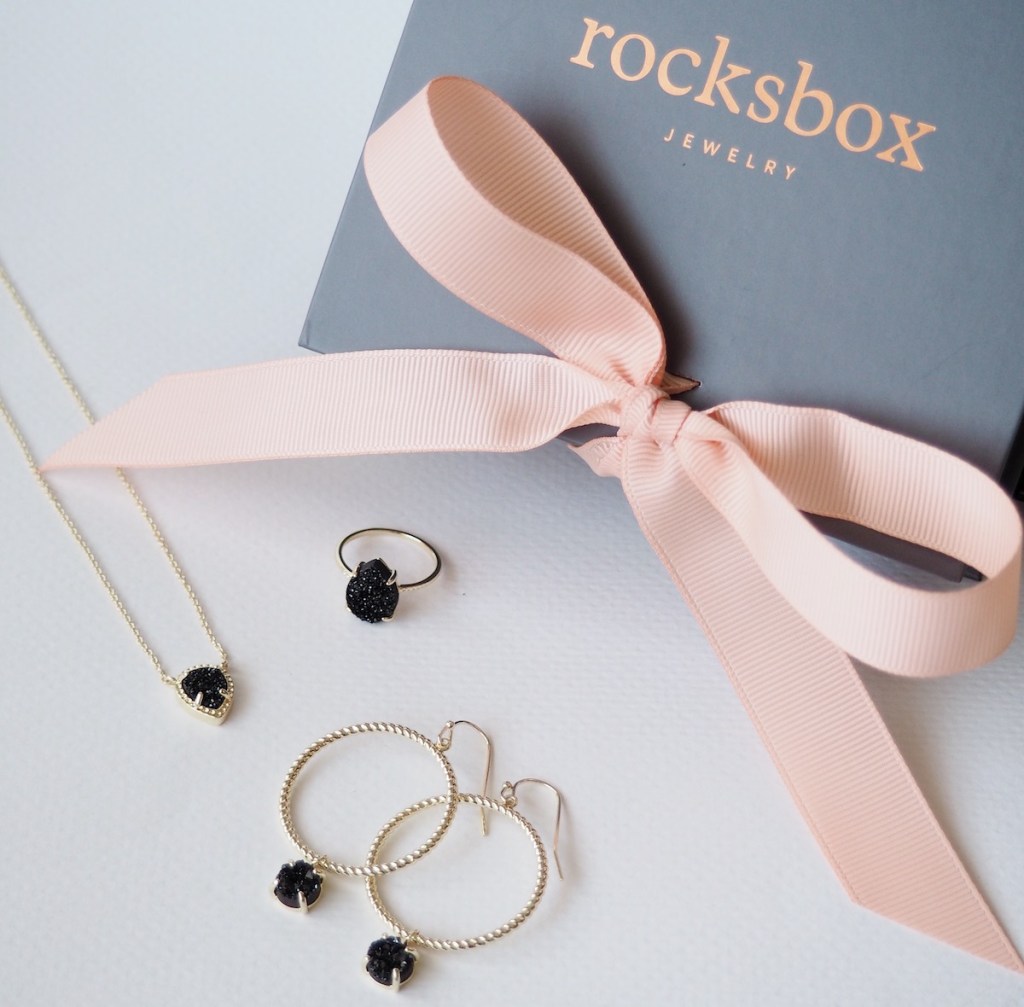 jewelry next to a box with a bow on it