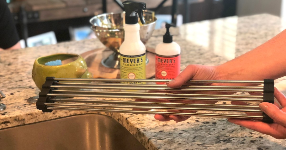 rolled up wire rod drying rack over kitchen sink with soap in the background