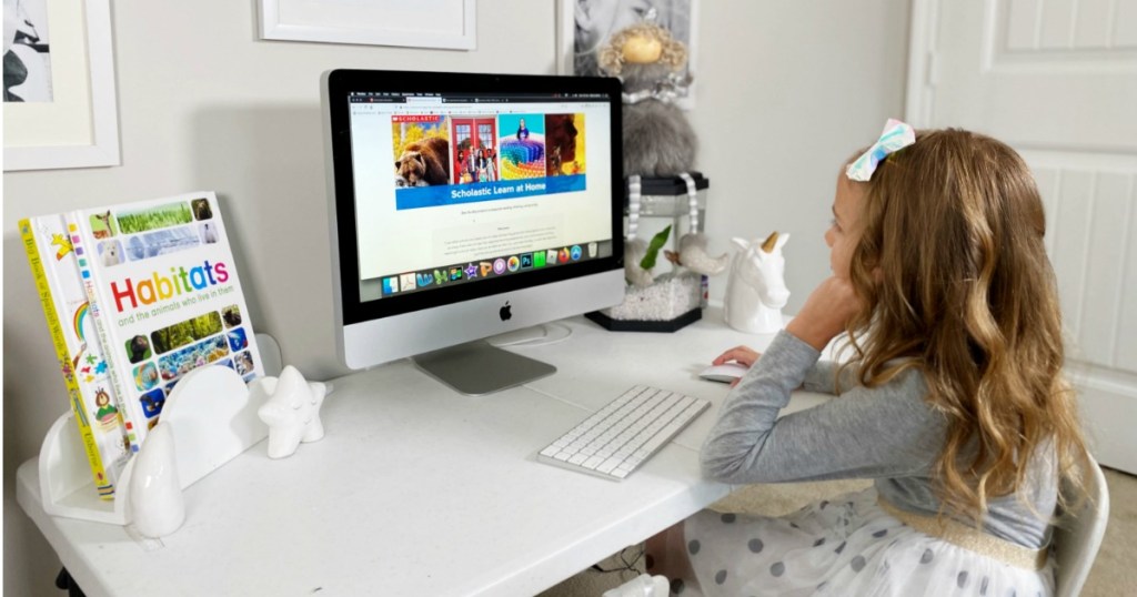 Girl playing Scholastic Learn at Home on computer