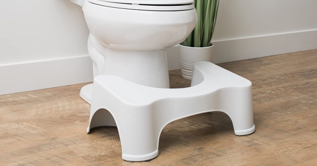 squatty potty in bathroom next to toilet