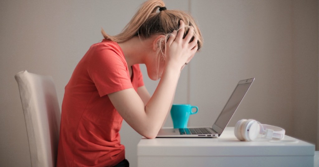 girl at desk starting at laptop