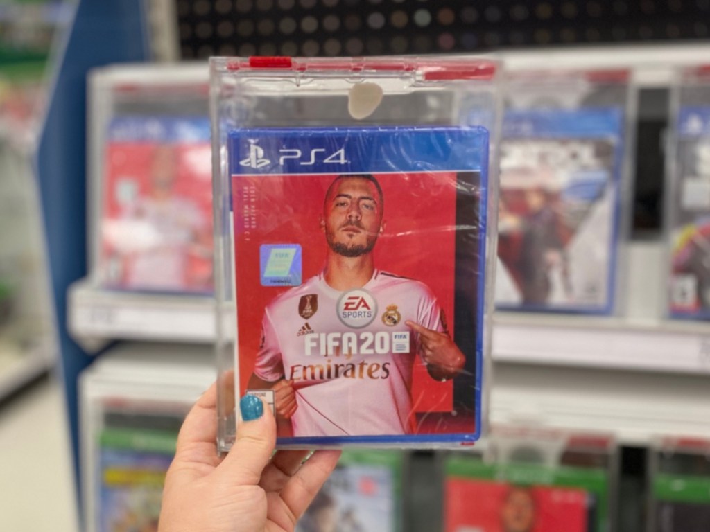 Hand holding FIFA 2020 playstation game at Target