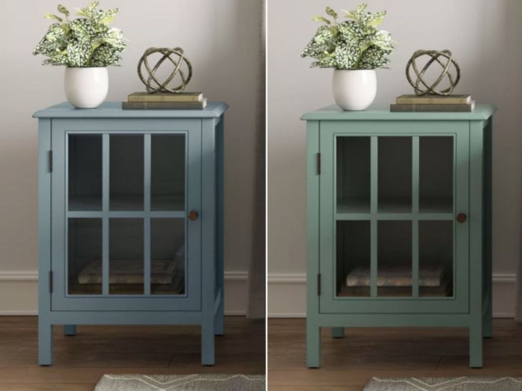 two wooden end tables with door and glass window with panes topped with potted plant and decorative metal accent