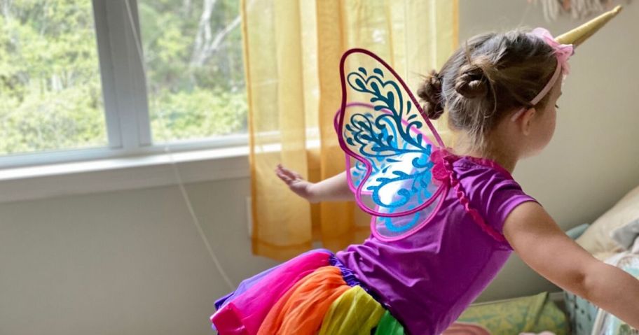 Little girl wearing tutu and wings for home theater activity