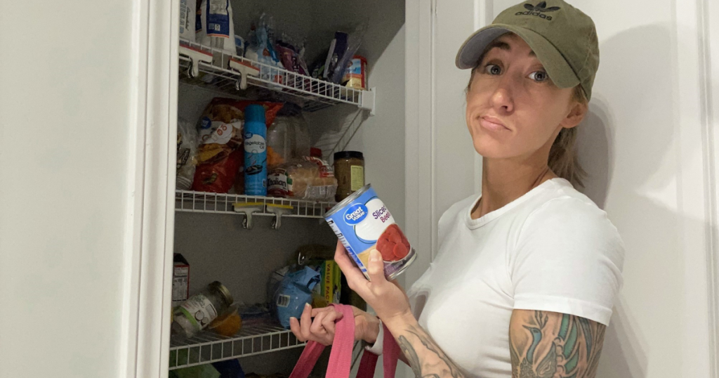 Woman in front of pantry holding can of beets