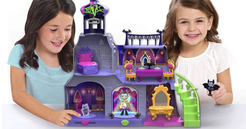 young girls playing with a kids castle toy