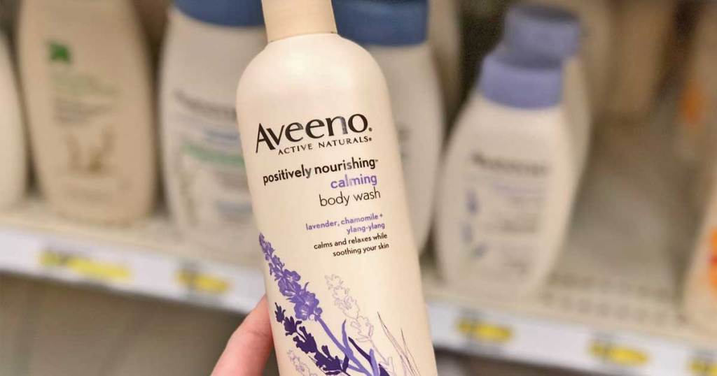 hand holding Aveeno Positively Nourishing Calming Body Wash